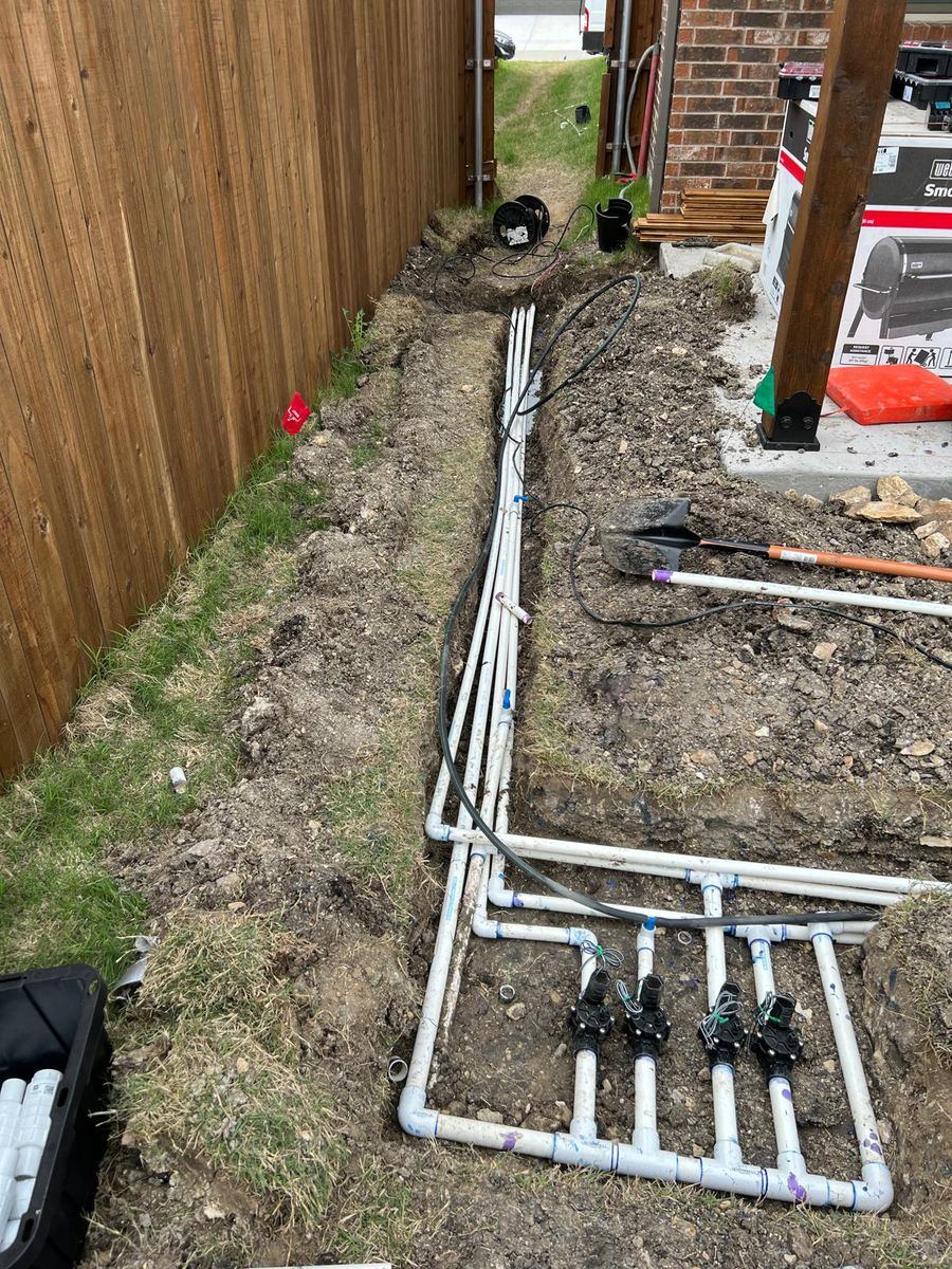 Sprinkler repair technician working on an irrigation system in Allen TX