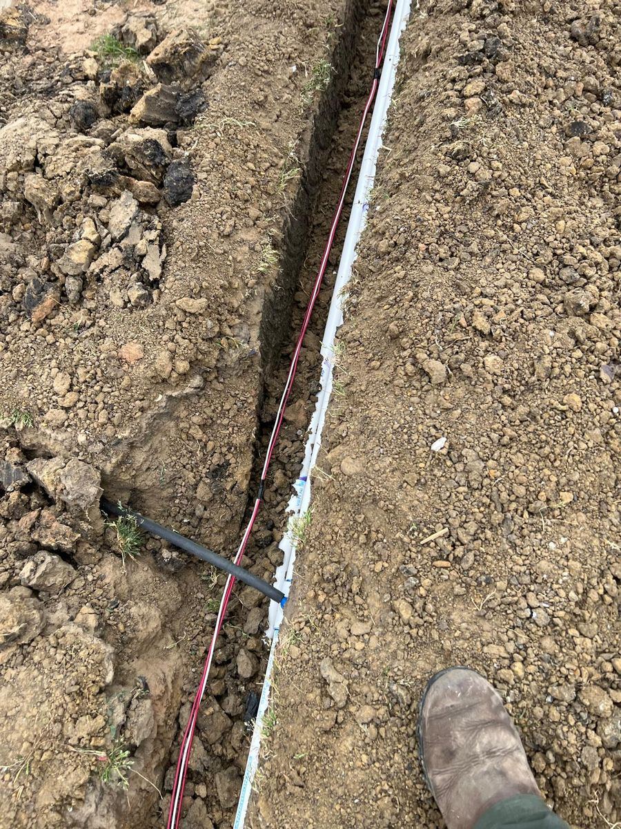 Sprinkler repair technician working on an irrigation system in Garland TX