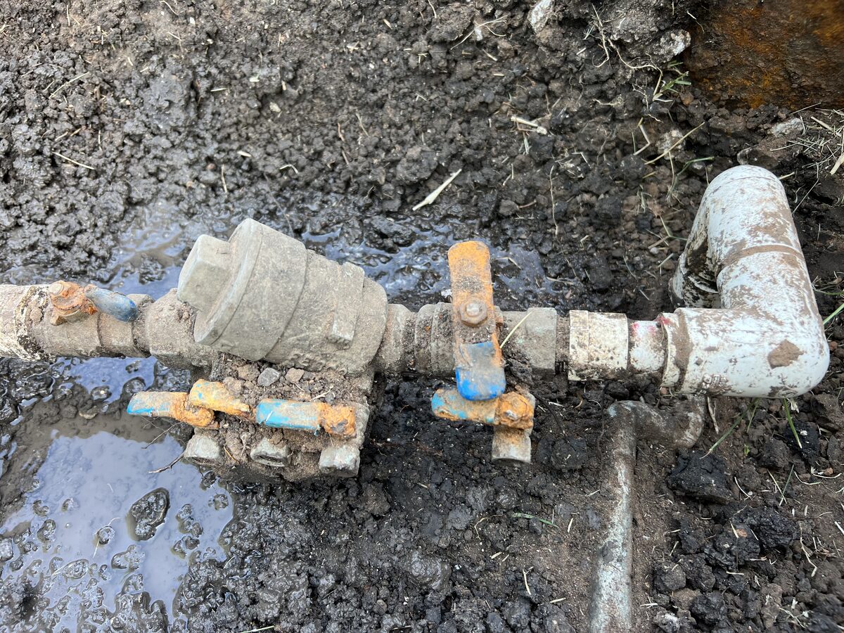 Underground irrigation pipe and backflow repair in a yard in Murphy TX