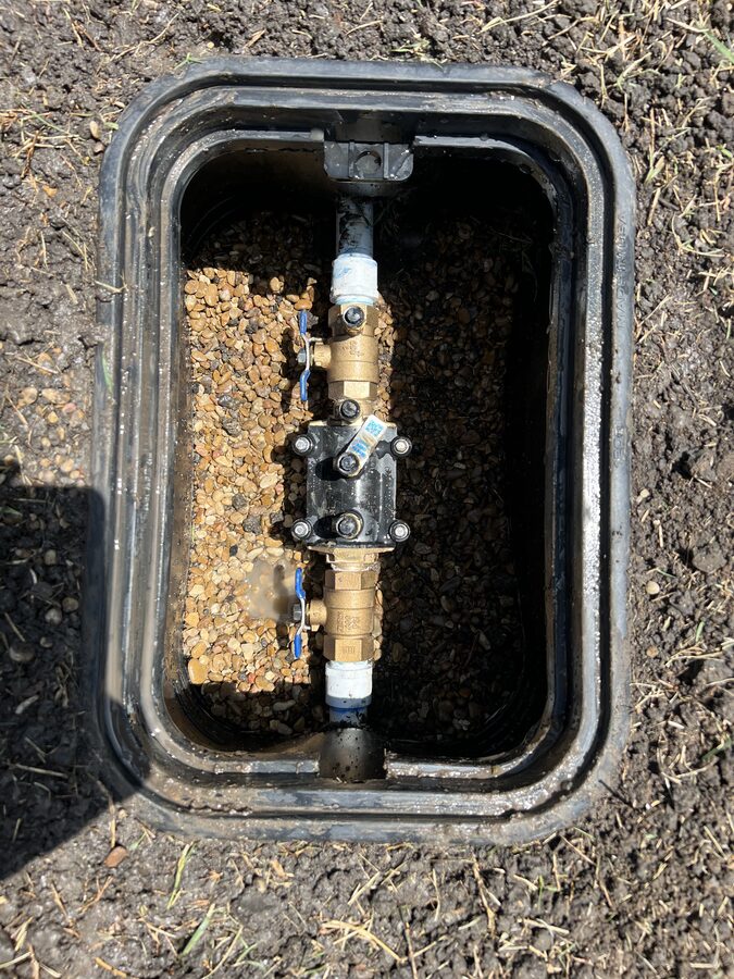 Backflow prevention valve installed in a yard in Parker TX