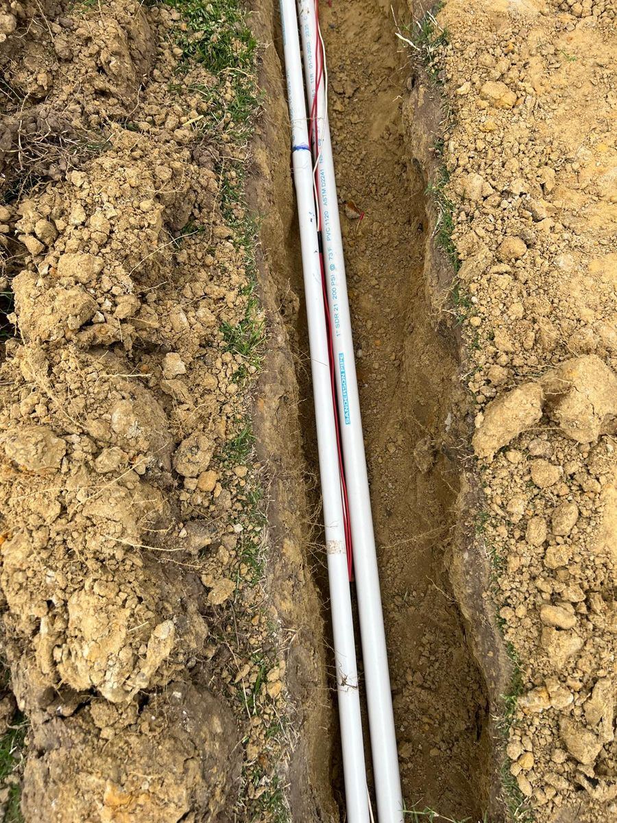Sprinkler repair technician working on an irrigation system in Plano TX